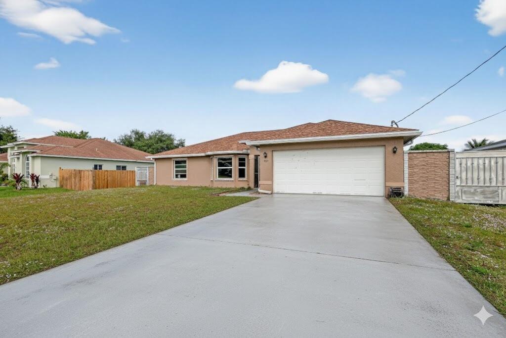 557 Southwest Halkell Avenue Port St. Lucie, FL 34953 - Photo 2 of 36 Front of house 2