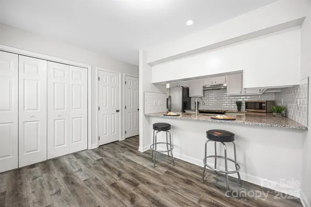 a kitchen with sink cabinets and stove top oven