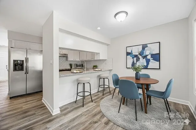 a view of a dining room with furniture and wooden floor