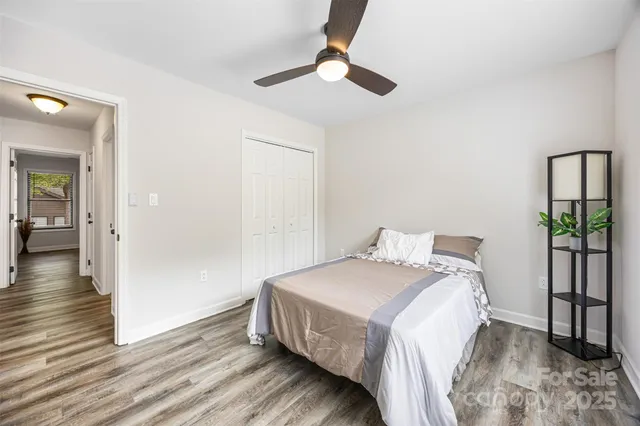 a bedroom with a bed and a chandelier