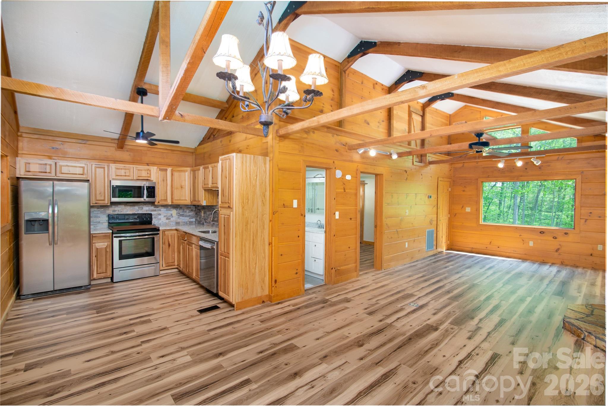 298 Timbuktu Road Sylva, NC 28779 - Photo 4 of 24 a view of a room with stainless steel appliances wooden floor and chandelier