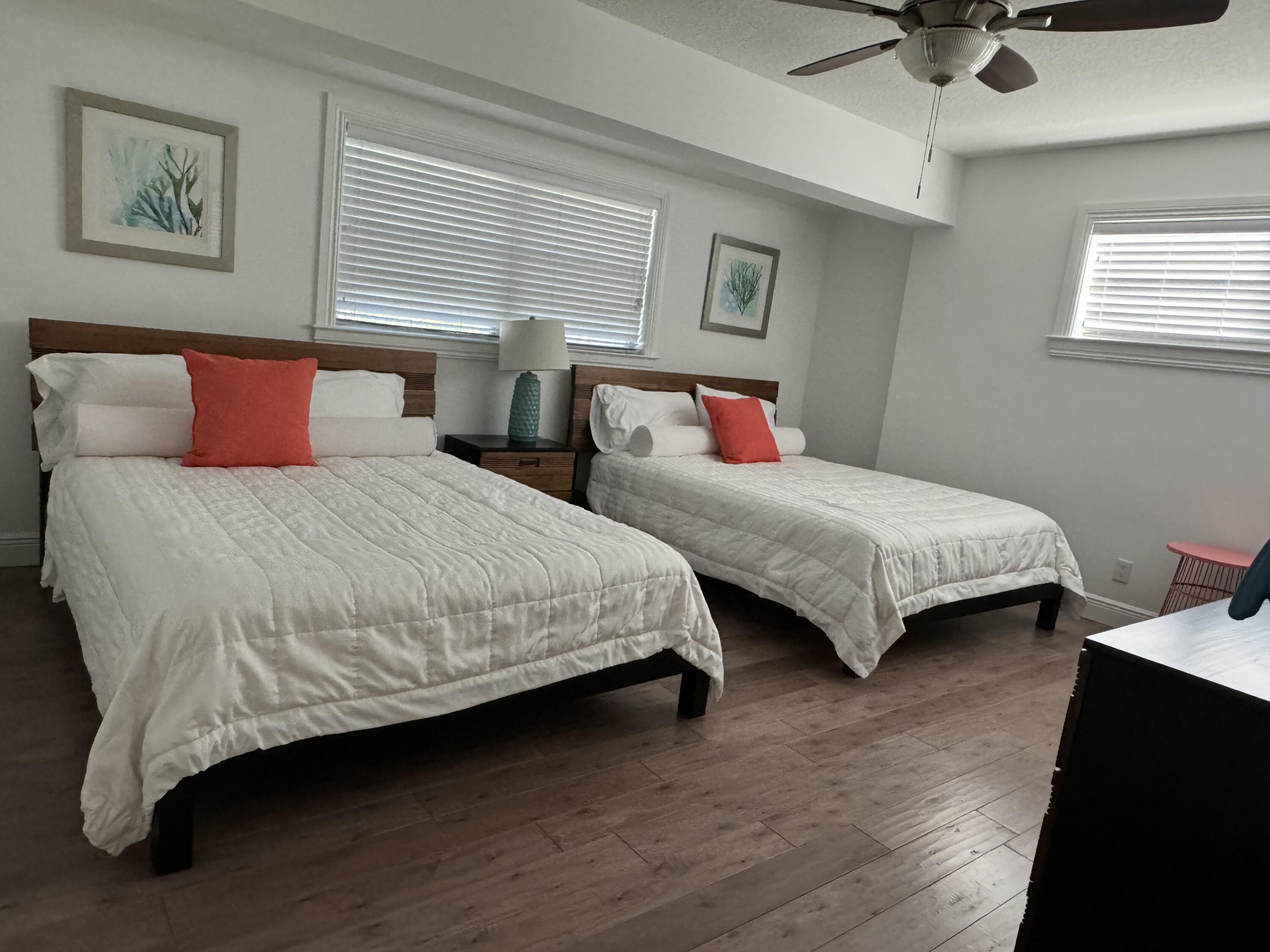 954 Marlin Circle Jupiter, FL 33458 - Photo 11 of 22 a bedroom with two beds and a chandelier