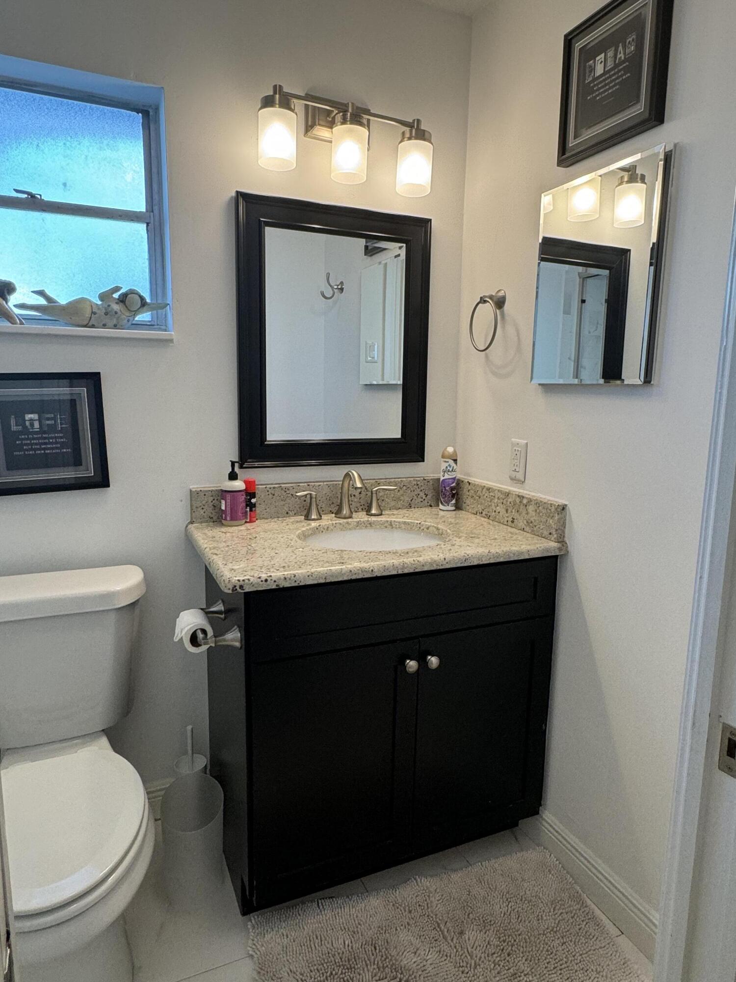 954 Marlin Circle Jupiter, FL 33458 - Photo 12 of 22 a bathroom with a sink vanity and a toilet