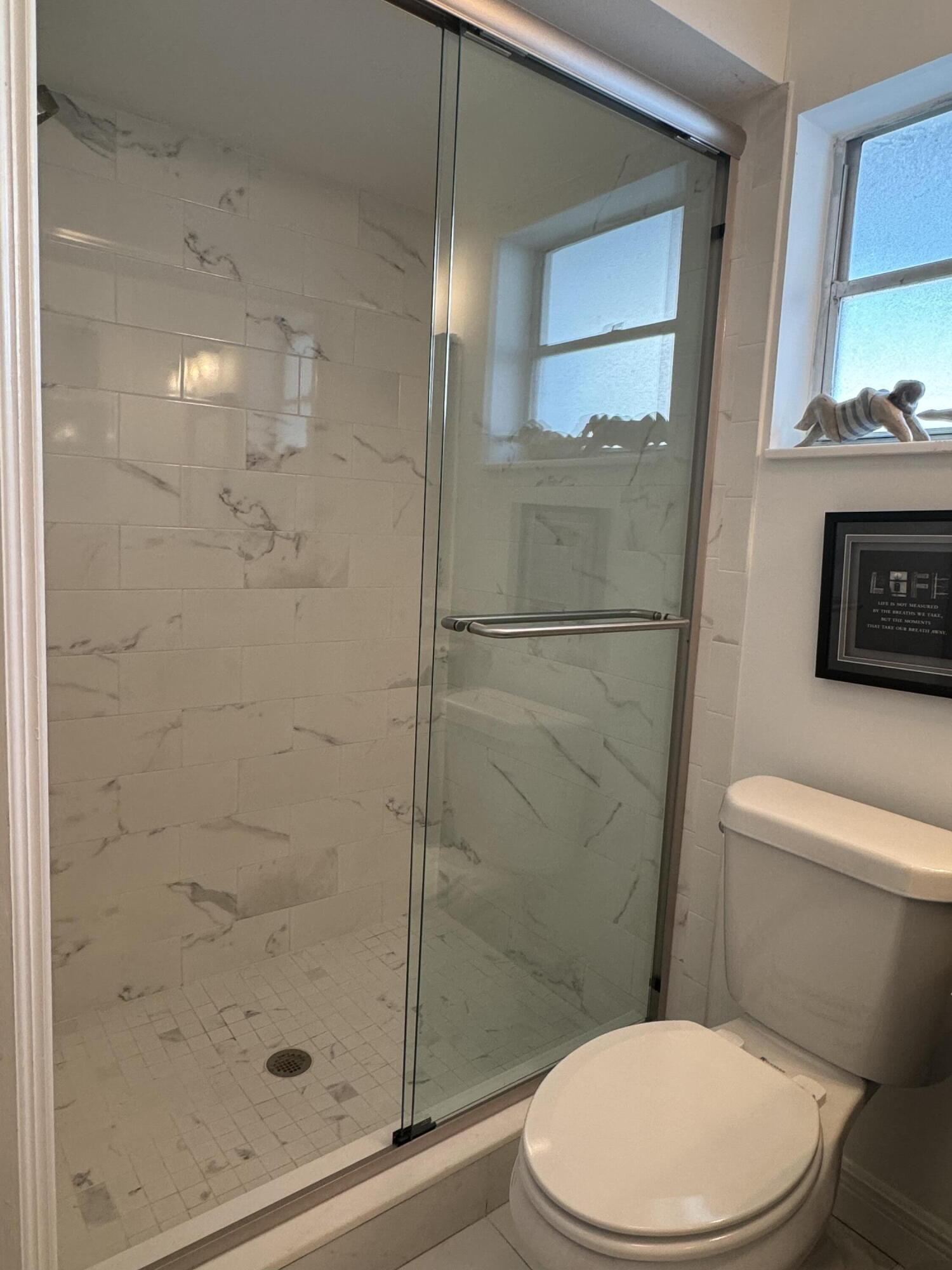 954 Marlin Circle Jupiter, FL 33458 - Photo 13 of 22 a white toilet next to a bathroom