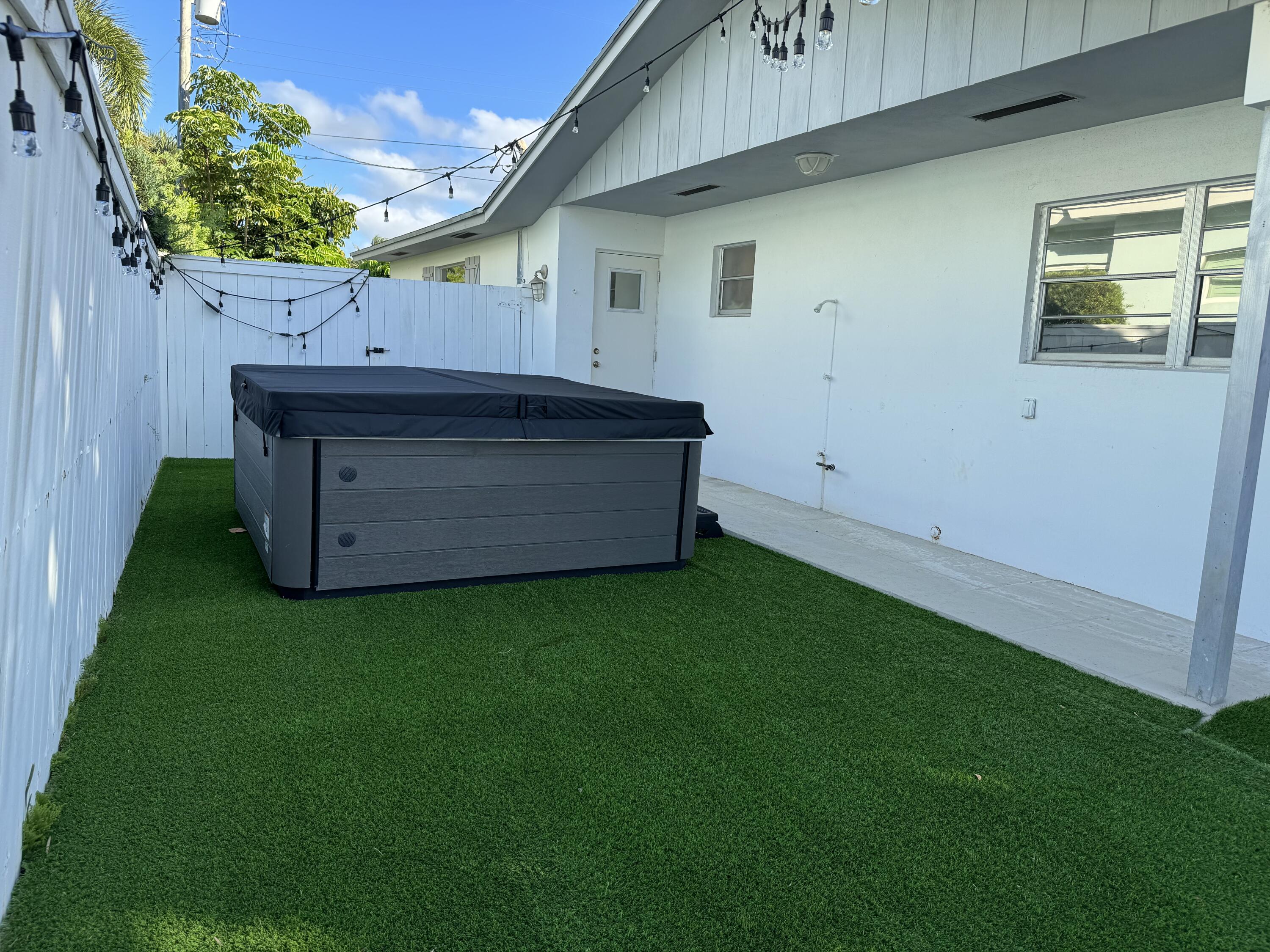 954 Marlin Circle Jupiter, FL 33458 - Photo 20 of 22 a backyard of a house with wooden fence and large trees