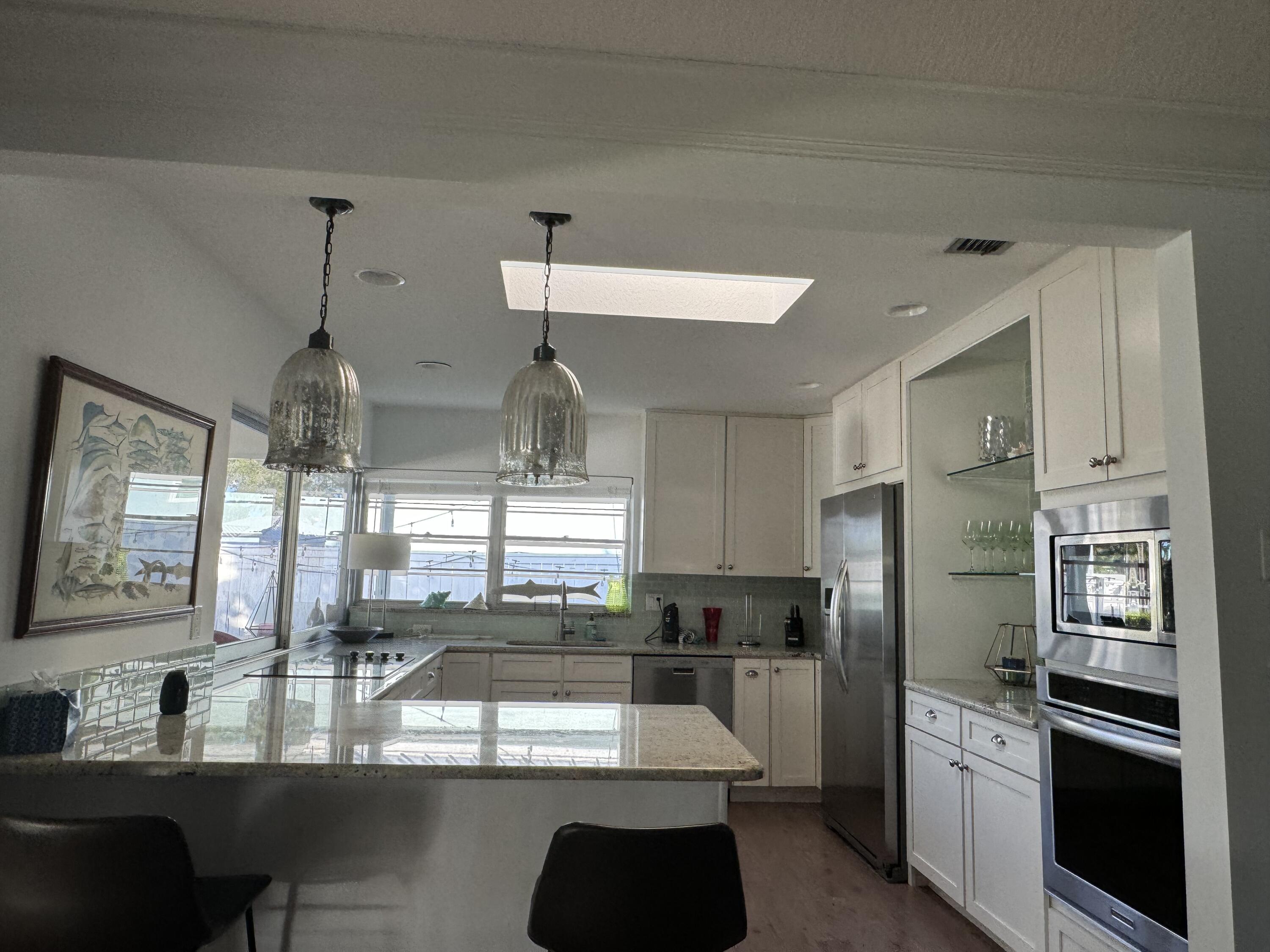 954 Marlin Circle Jupiter, FL 33458 - Photo 5 of 22 a kitchen with refrigerator and window