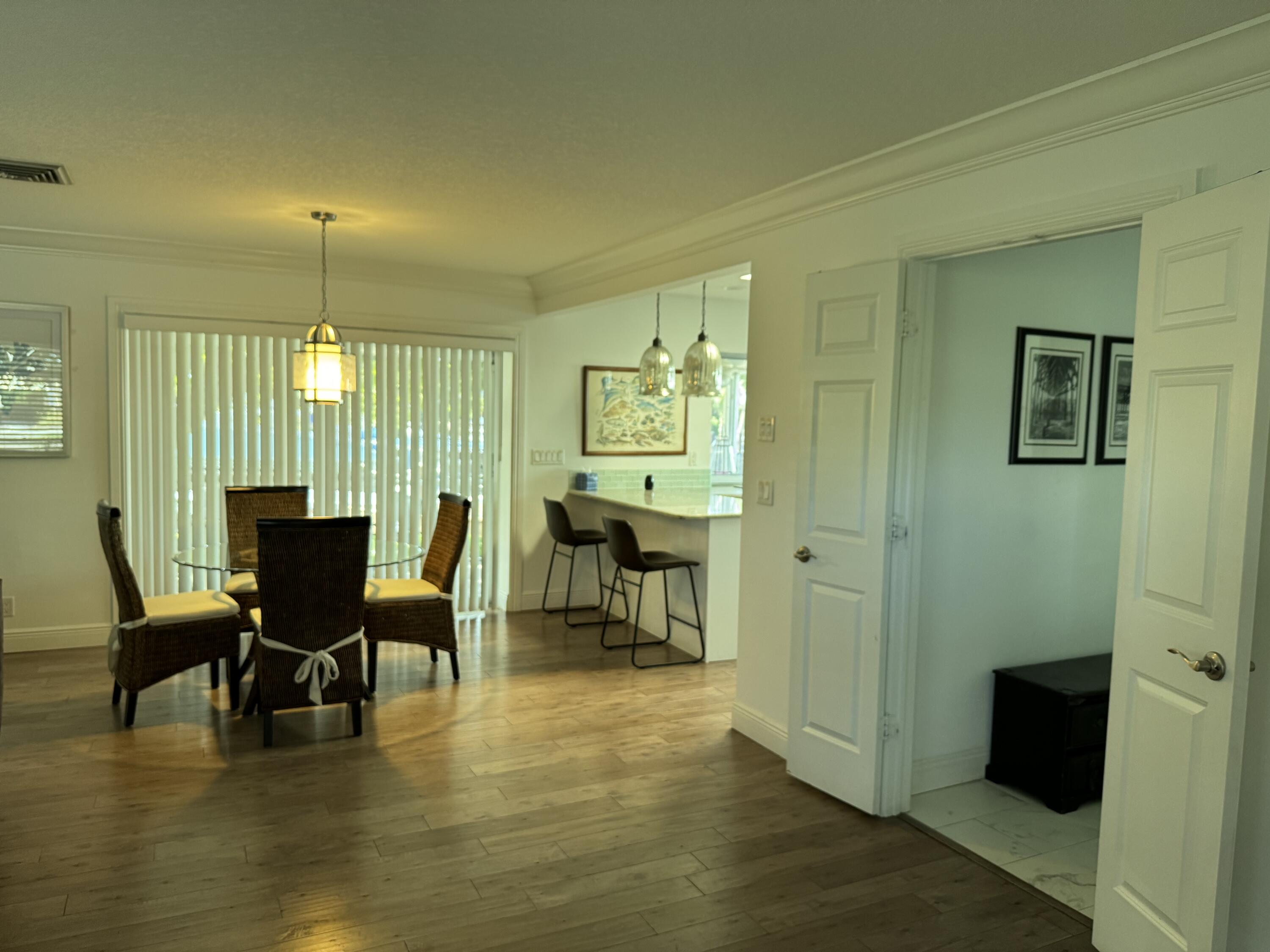 954 Marlin Circle Jupiter, FL 33458 - Photo 8 of 22 a workspace with furniture window and wooden floor