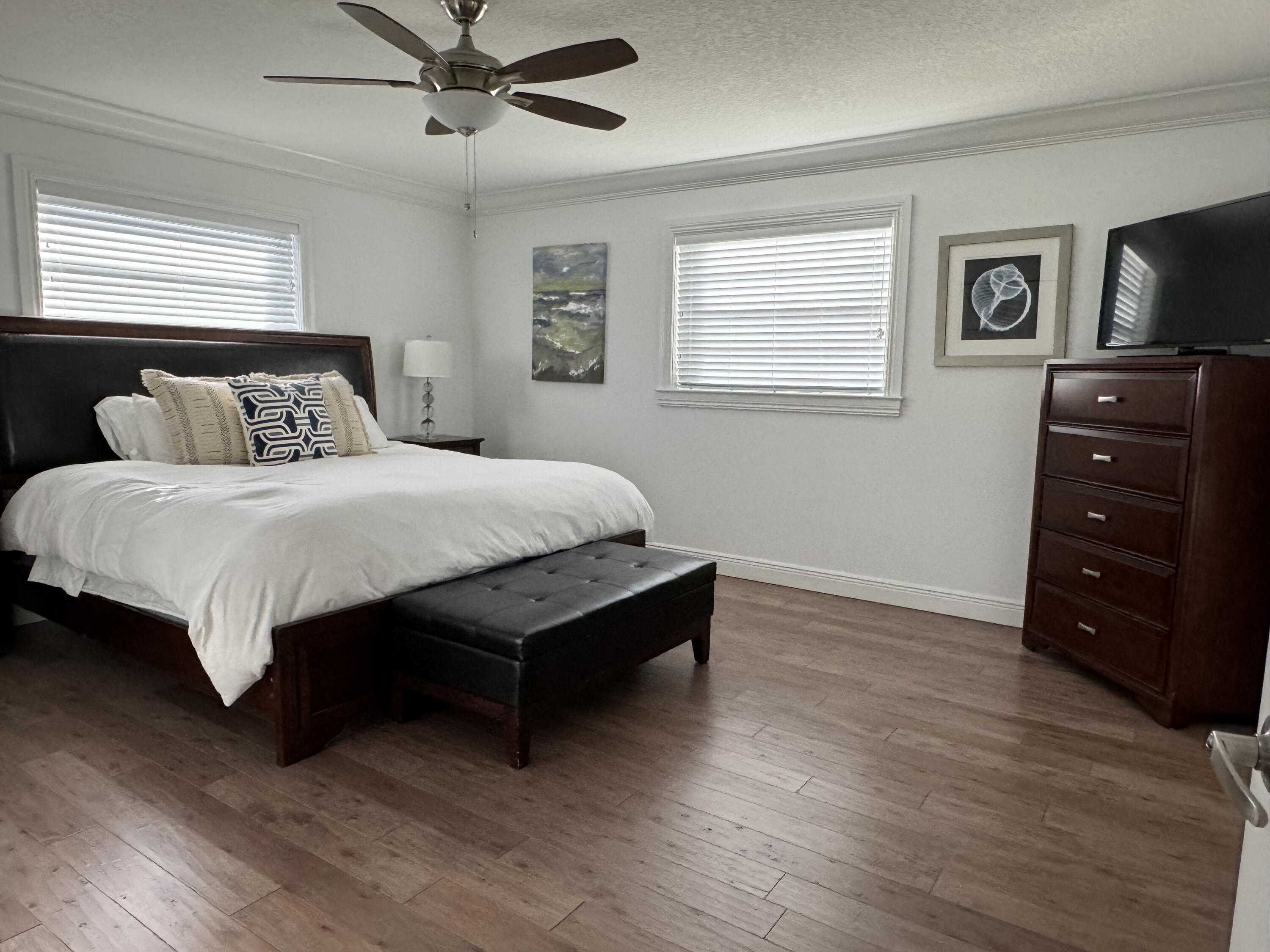 954 Marlin Circle Jupiter, FL 33458 - Photo 9 of 22 a bedroom with a bed and a tv