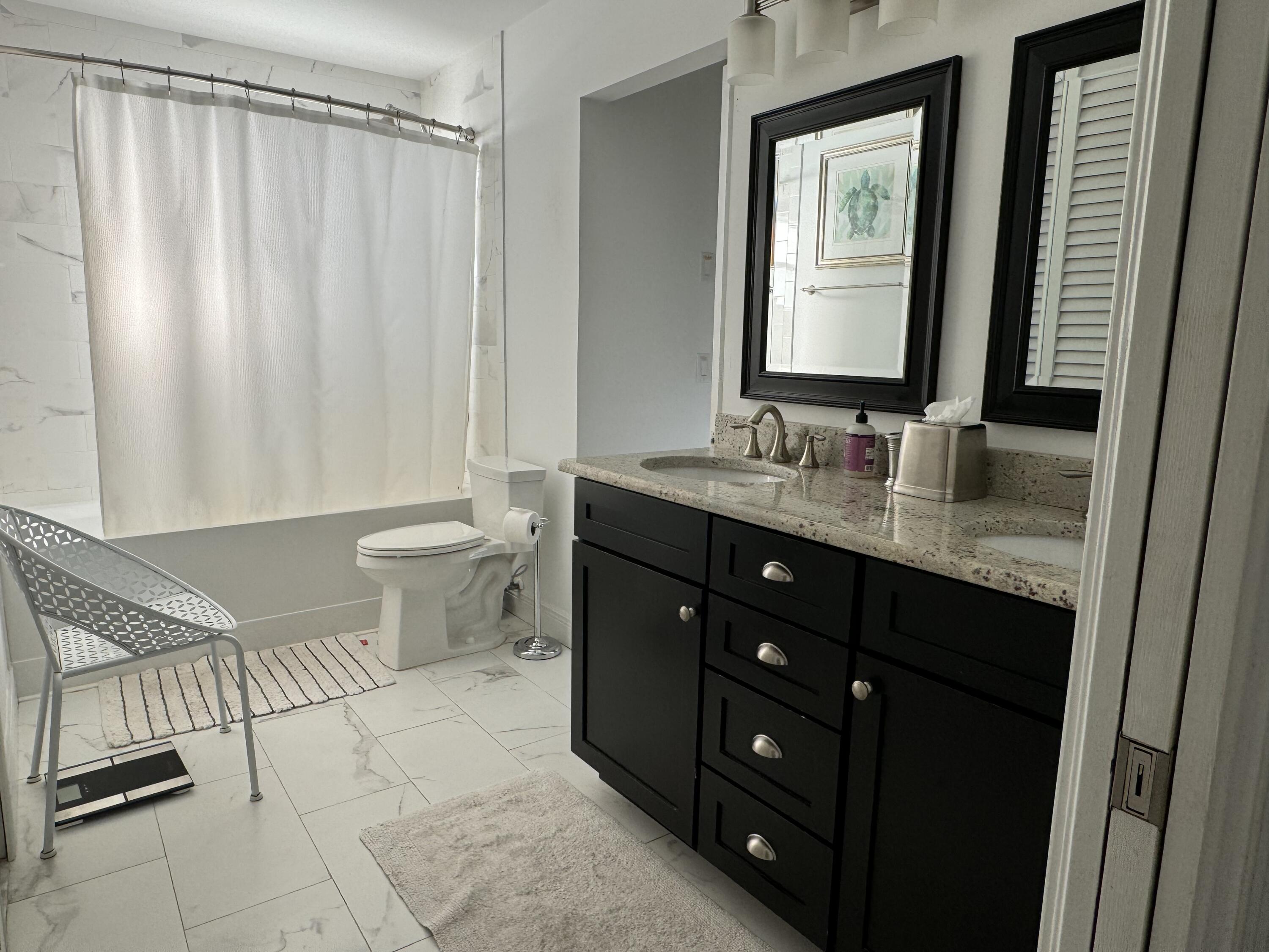 954 Marlin Circle Jupiter, FL 33458 - Photo 10 of 22 a bathroom with a double vanity sink toilet and a mirror