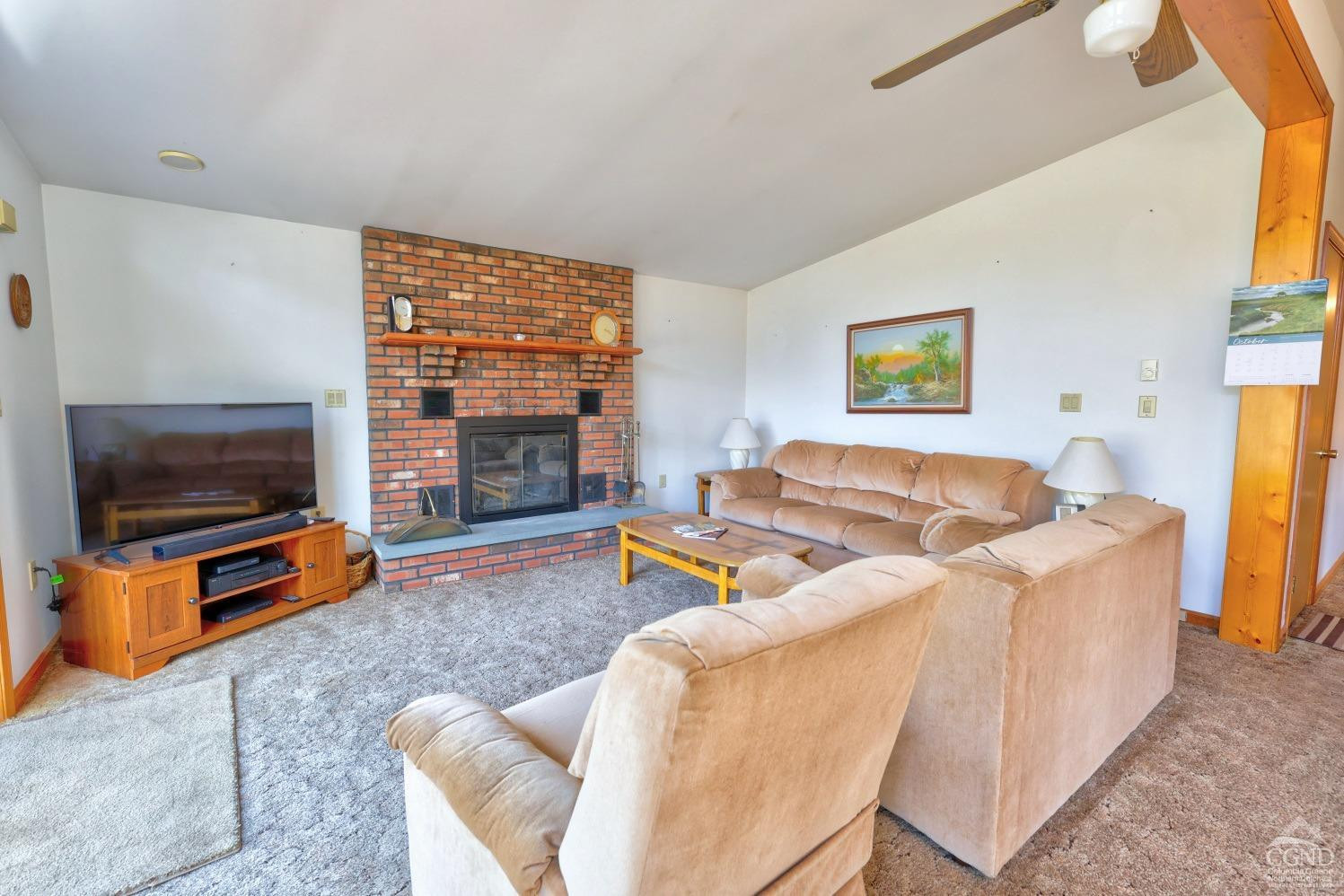 496 New Forge Road Ancram, NY 12502 - Photo 33 of 87 a living room with furniture a flat screen tv and a fireplace