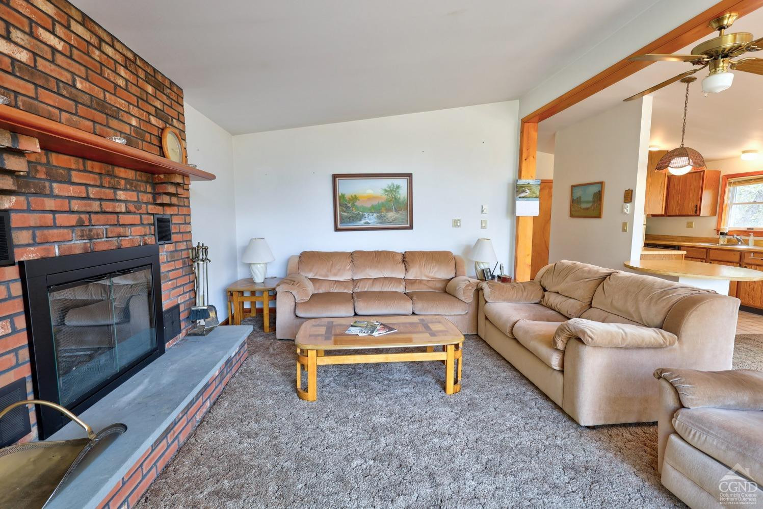 496 New Forge Road Ancram, NY 12502 - Photo 34 of 87 a living room with furniture a fireplace and a flat screen tv