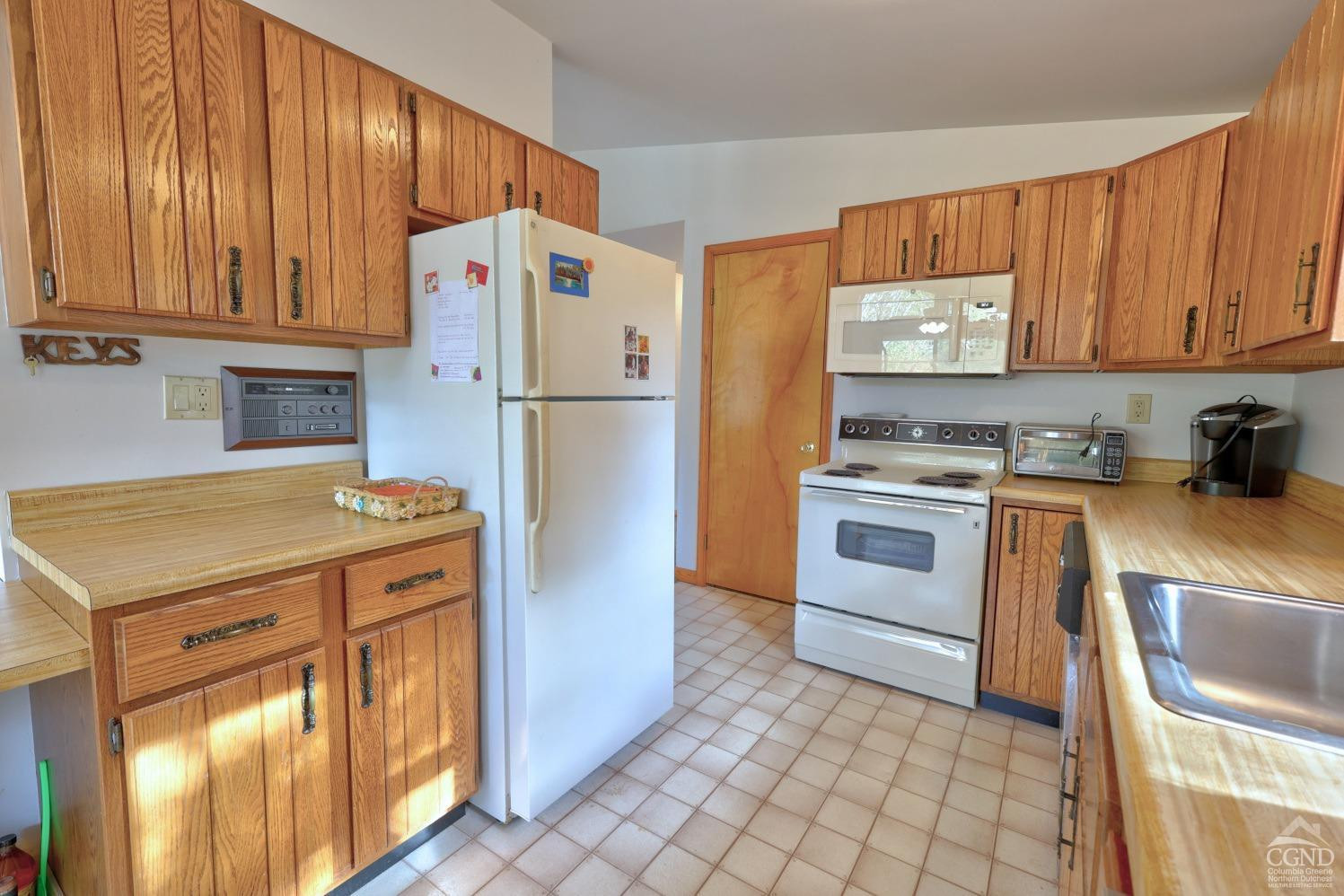 496 New Forge Road Ancram, NY 12502 - Photo 41 of 87 a kitchen with a stove a sink and a refrigerator