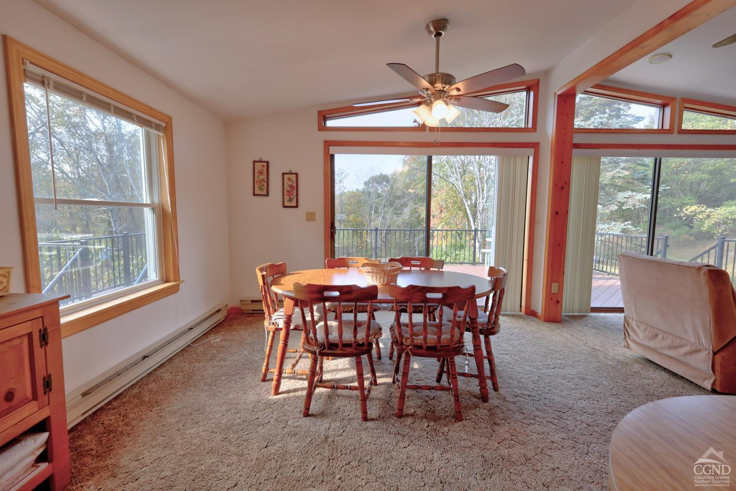 496 New Forge Road Ancram, NY 12502 - Photo 44 of 87 a dining room with furniture a chandelier and a rug