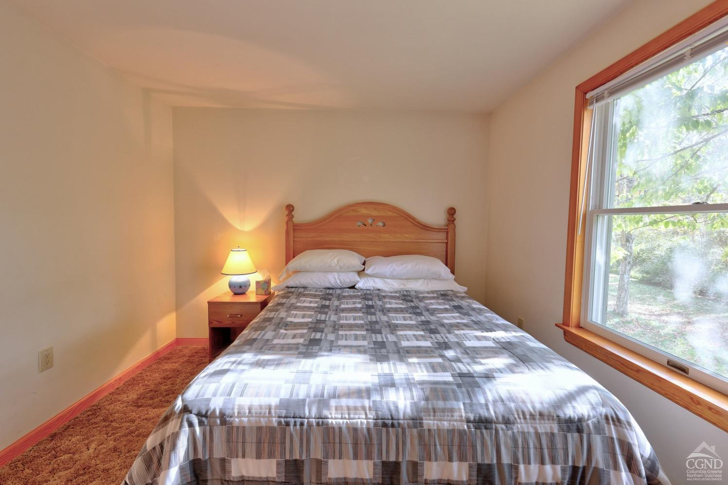 496 New Forge Road Ancram, NY 12502 - Photo 52 of 87 a bedroom with a bed and wooden floor