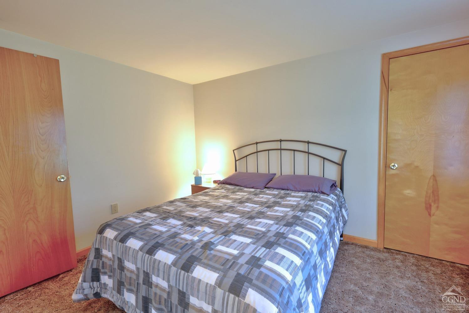 496 New Forge Road Ancram, NY 12502 - Photo 56 of 87 a bedroom with a bed and a table