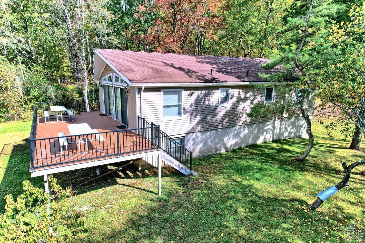 496 New Forge Road Ancram, NY 12502 - Photo 6 of 87 a view of a house with a yard deck and furniture