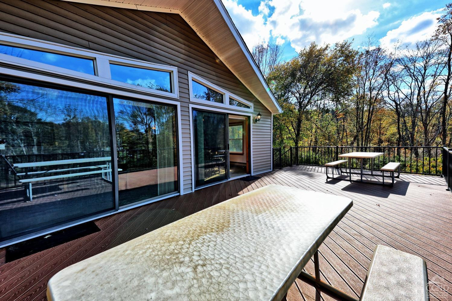 496 New Forge Road Ancram, NY 12502 - Photo 67 of 87 a view of a patio with a table chairs and a backyard