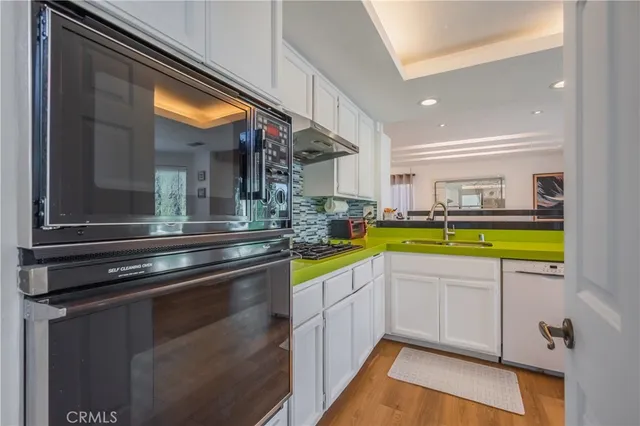 a kitchen with a sink and a stove top oven