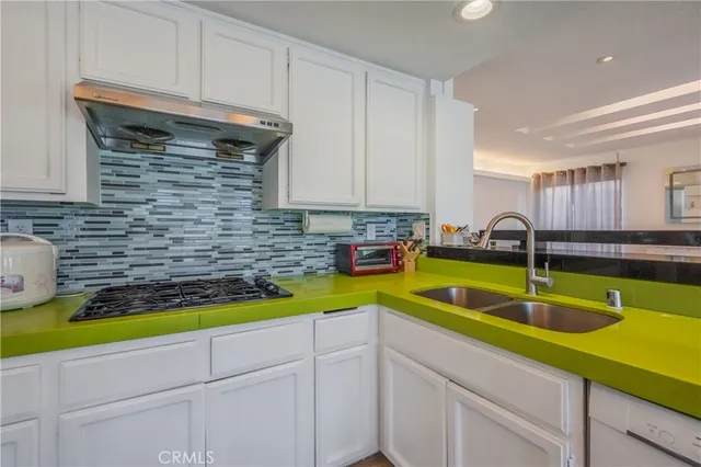 a kitchen with a sink and cabinets