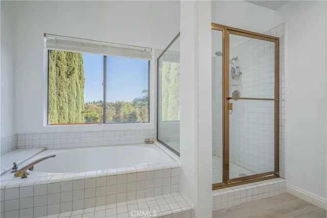 a bathroom with a bathtub and shower