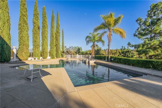 a view of swimming pool with outdoor seating and plants