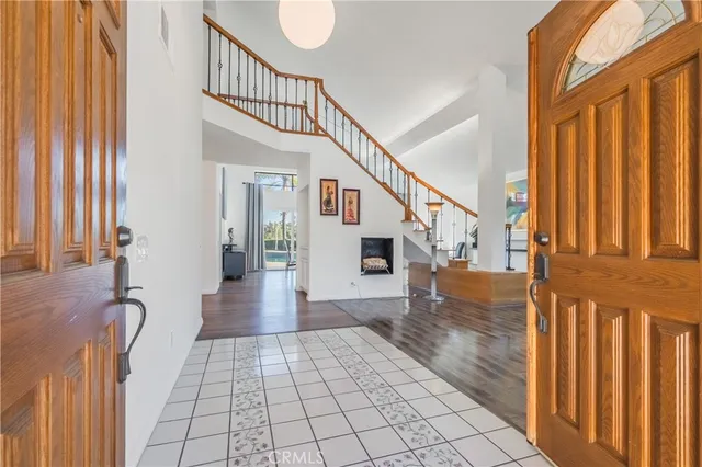 a view of entryway with wooden floor and front door