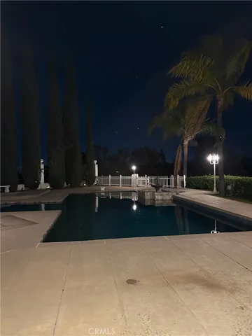 a view of swimming pool with outdoor seating and yard