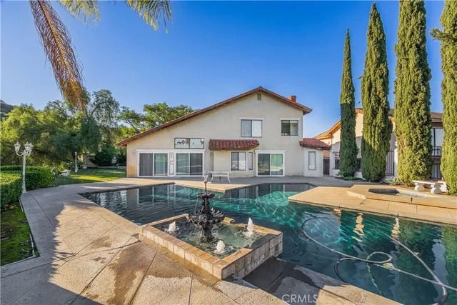 a view of a house with backyard and sitting area