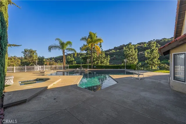a view of a swimming pool with a lounge chair