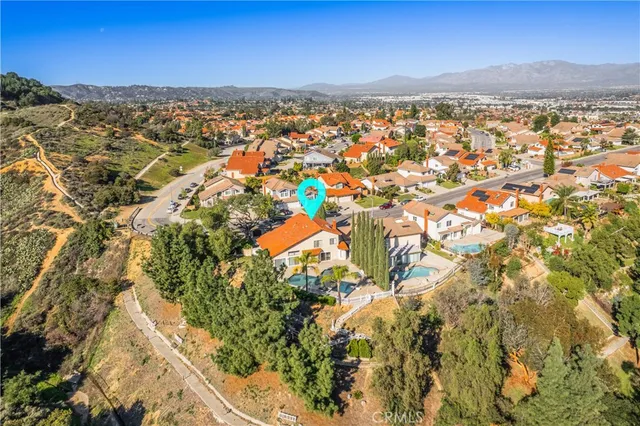 a view of a house with a small yard and large tree