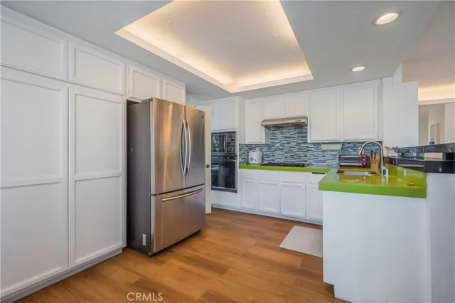 a kitchen with stainless steel appliances granite countertop a refrigerator and a stove