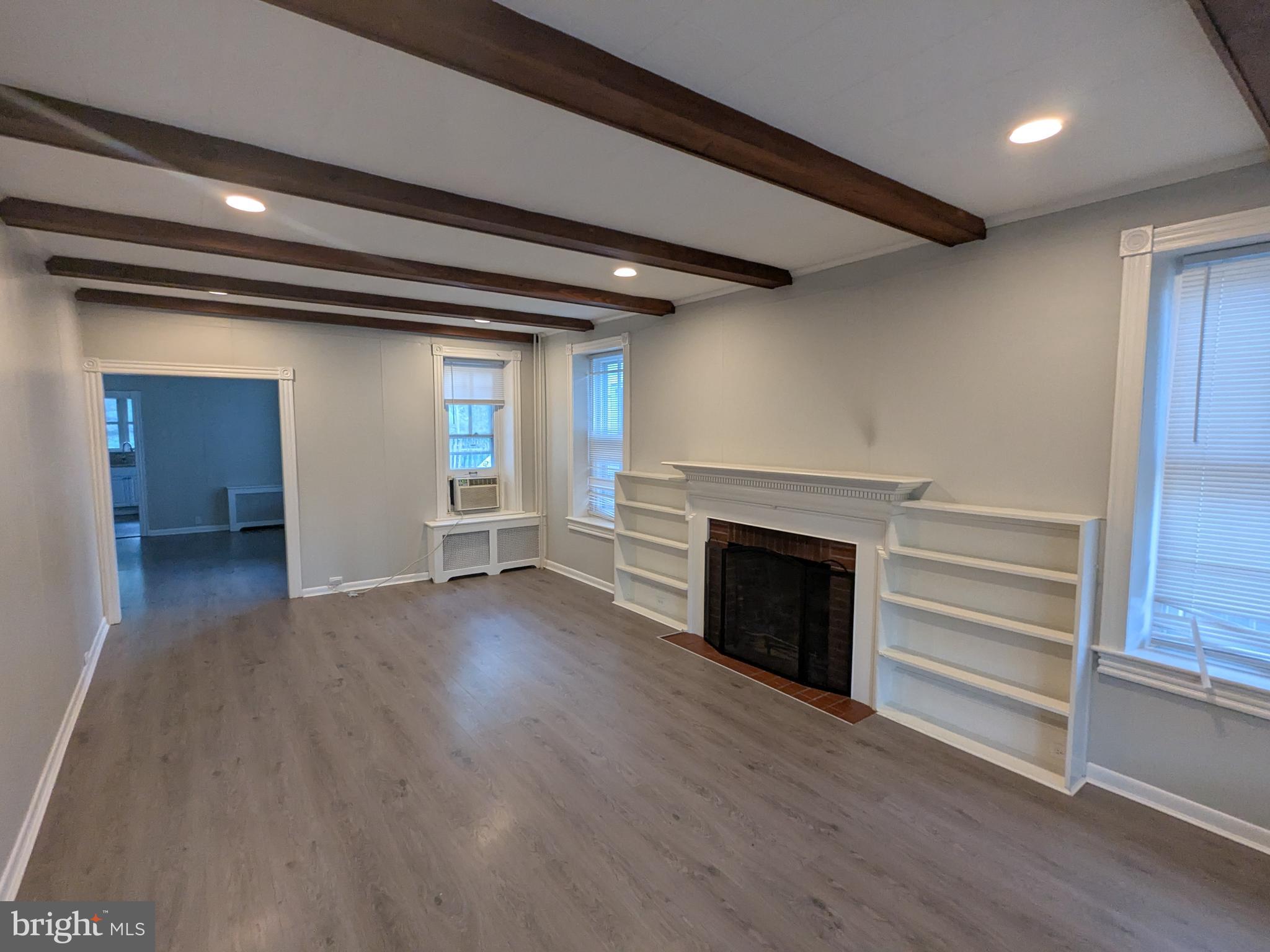 4133 Penn Avenue Sinking Spring, PA 19608 - Photo 20 of 53 an empty room with wooden floor fireplace and windows