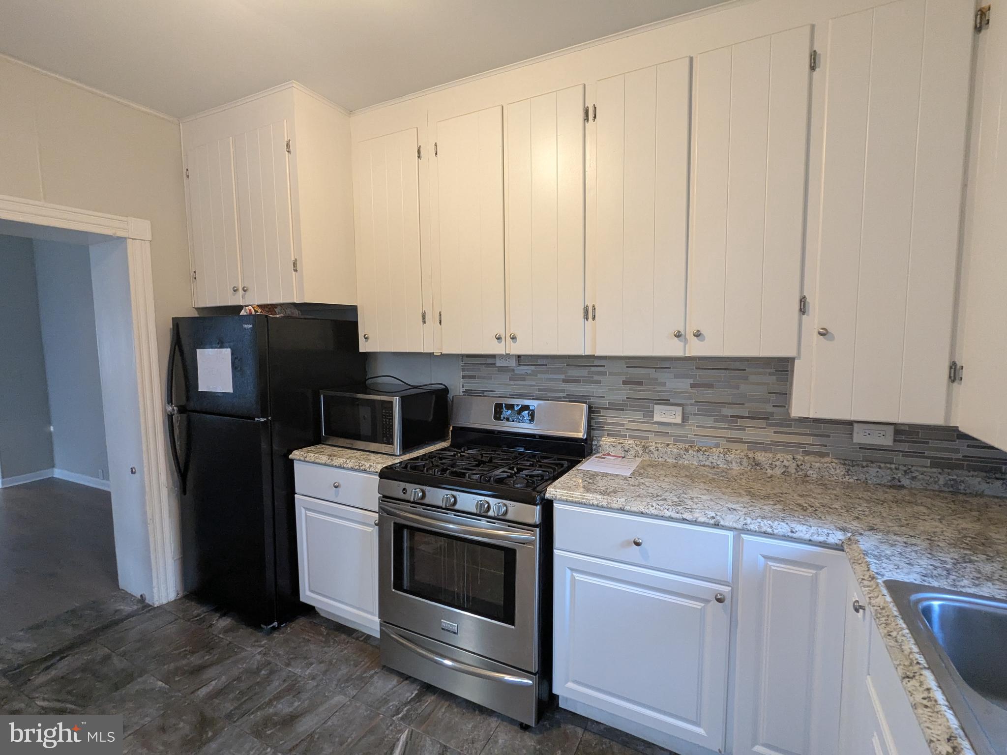 4133 Penn Avenue Sinking Spring, PA 19608 - Photo 25 of 53 a kitchen with granite countertop white cabinets and stainless steel appliances
