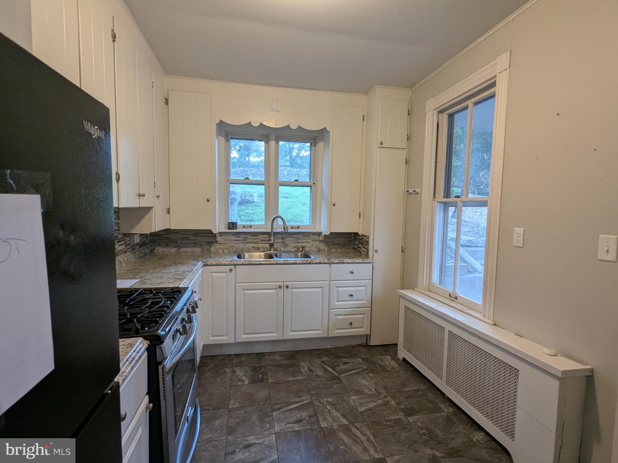 4133 Penn Avenue Sinking Spring, PA 19608 - Photo 28 of 53 a kitchen with a sink stove and cabinets