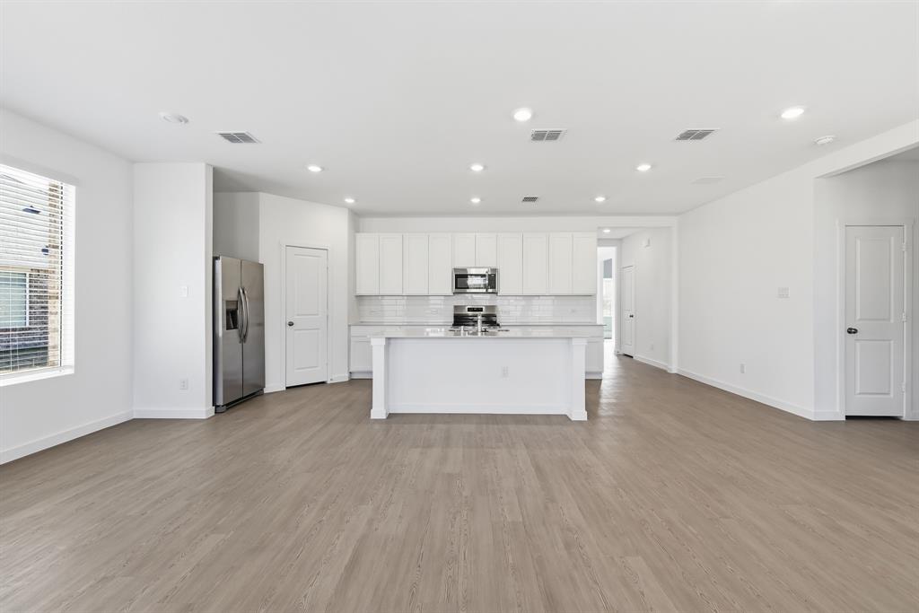 4912 Ascot Way Princeton, TX 75407 - Photo 11 of 35 a view of kitchen with wooden floor