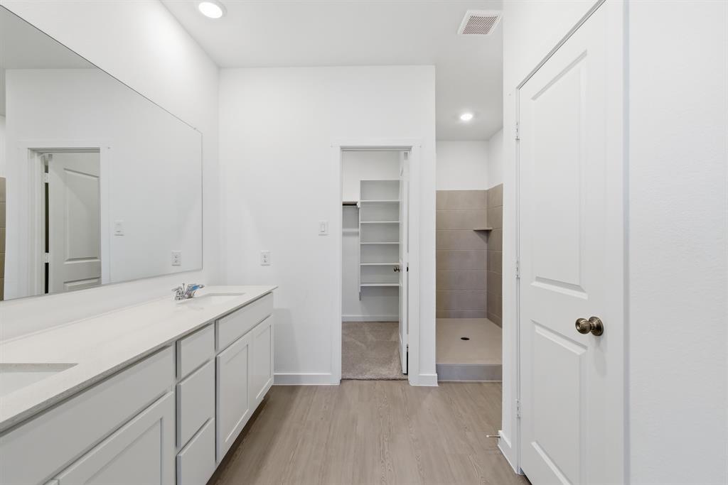 4912 Ascot Way Princeton, TX 75407 - Photo 25 of 35 a bathroom with a sink and a mirror