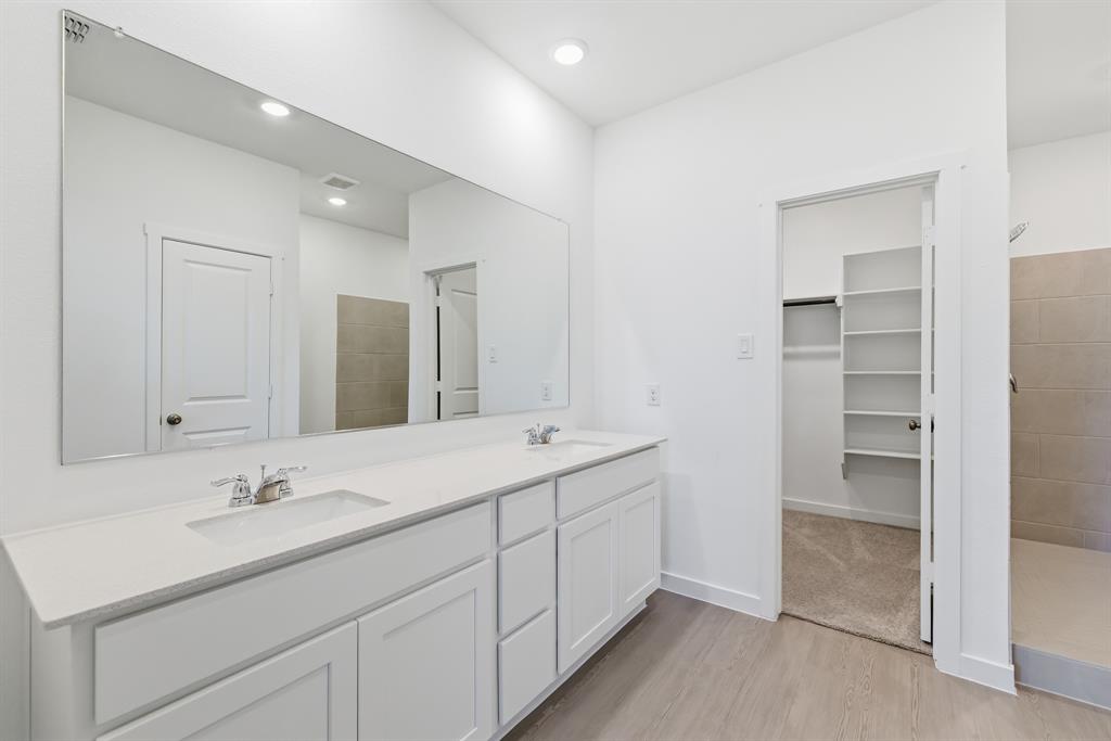 4912 Ascot Way Princeton, TX 75407 - Photo 26 of 35 a bathroom with double sink and a mirror