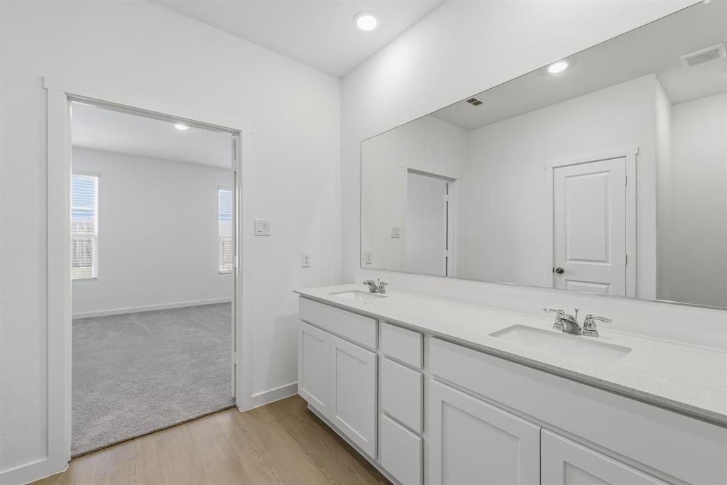 4912 Ascot Way Princeton, TX 75407 - Photo 29 of 35 a bathroom with a sink and a mirror
