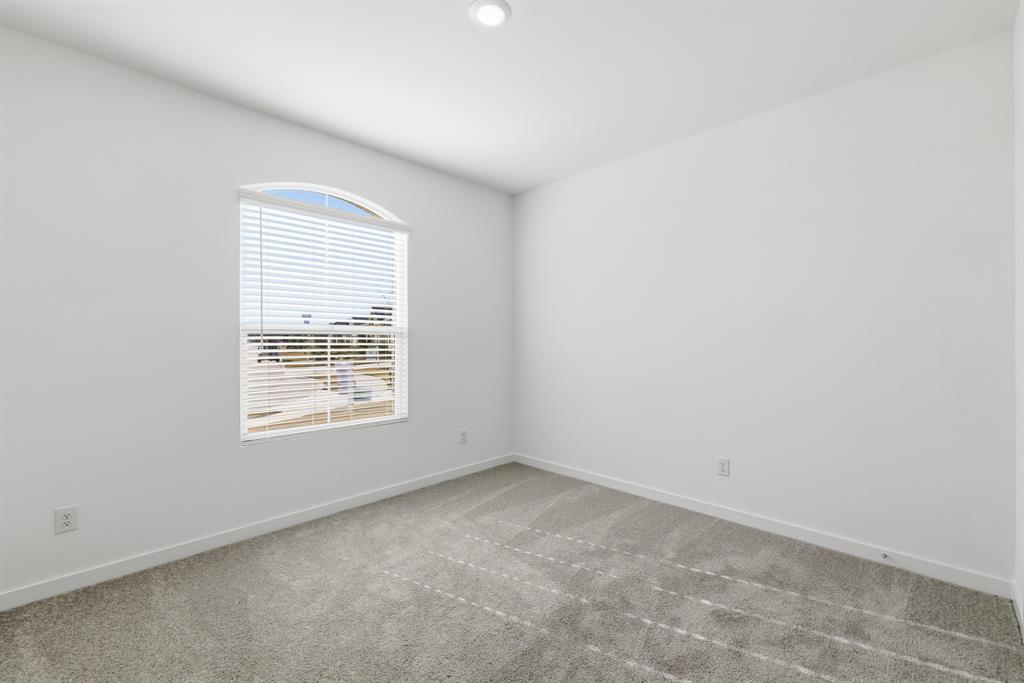4912 Ascot Way Princeton, TX 75407 - Photo 4 of 35 an empty room with a window