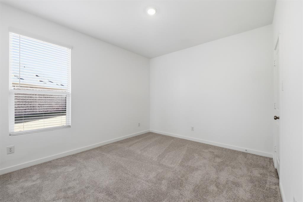 4912 Ascot Way Princeton, TX 75407 - Photo 6 of 35 an empty room with a window