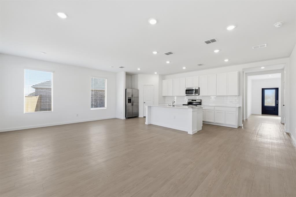 4912 Ascot Way Princeton, TX 75407 - Photo 10 of 35 a view of a kitchen with a sink and a refrigerator