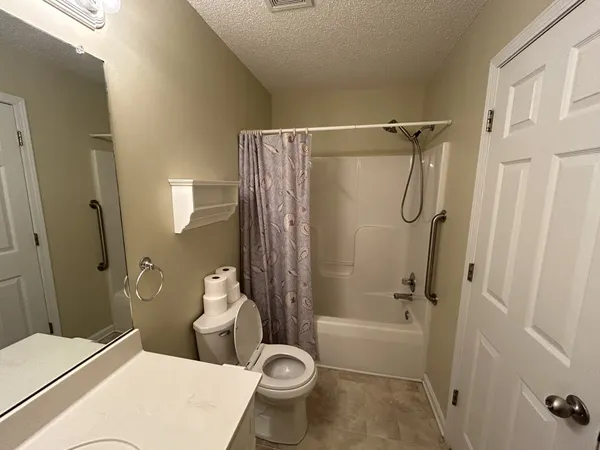 a bathroom with a sink a vanity and shower