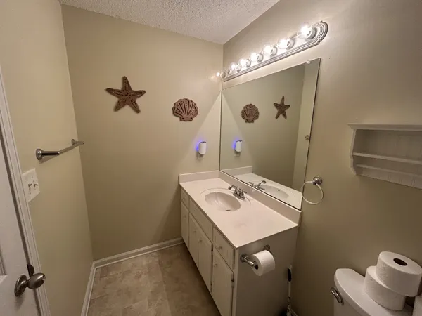 a view of an empty room with a chandelier fan