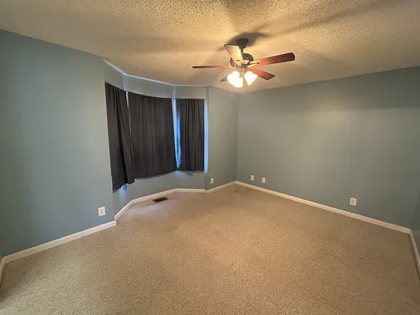 a view of a chandelier fan and entryway