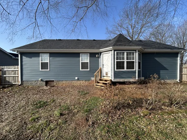 a view of yard covered with snow in front of house