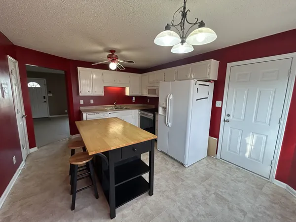 a room with pool table and a chandelier