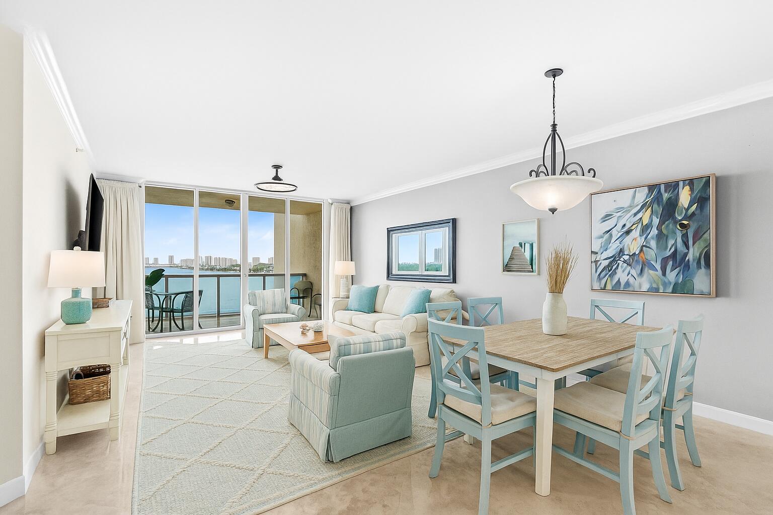 a dining room with furniture wooden floor and a chandelier