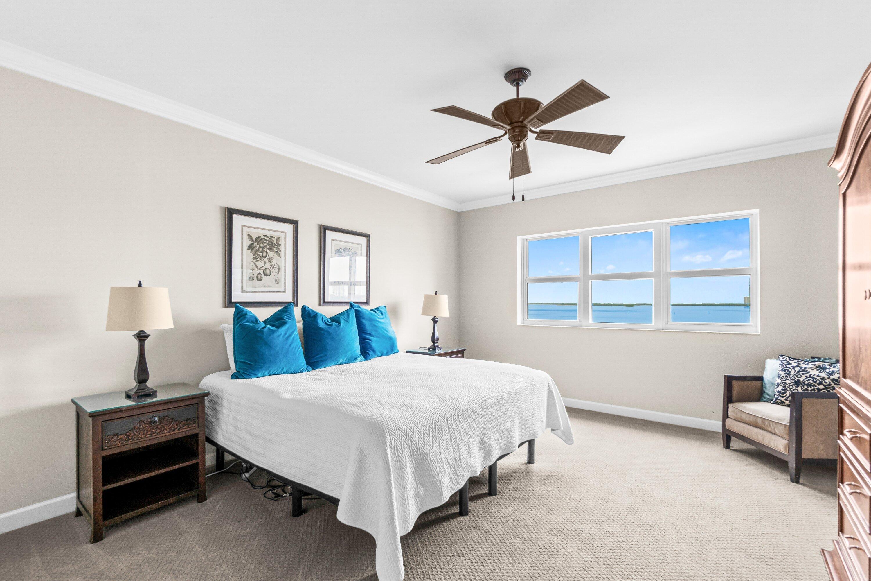 2650 Lake Shore Drive, Unit 703 Riviera Beach, FL 33404 - Photo 13 of 56 a bedroom with a bed and dresser