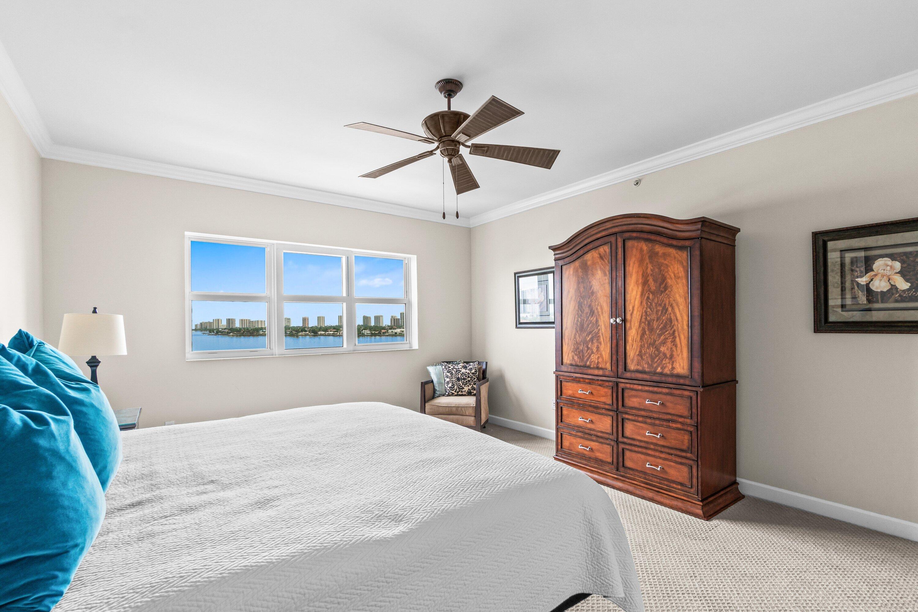 2650 Lake Shore Drive, Unit 703 Riviera Beach, FL 33404 - Photo 14 of 56 a bedroom with a bed dresser and a window