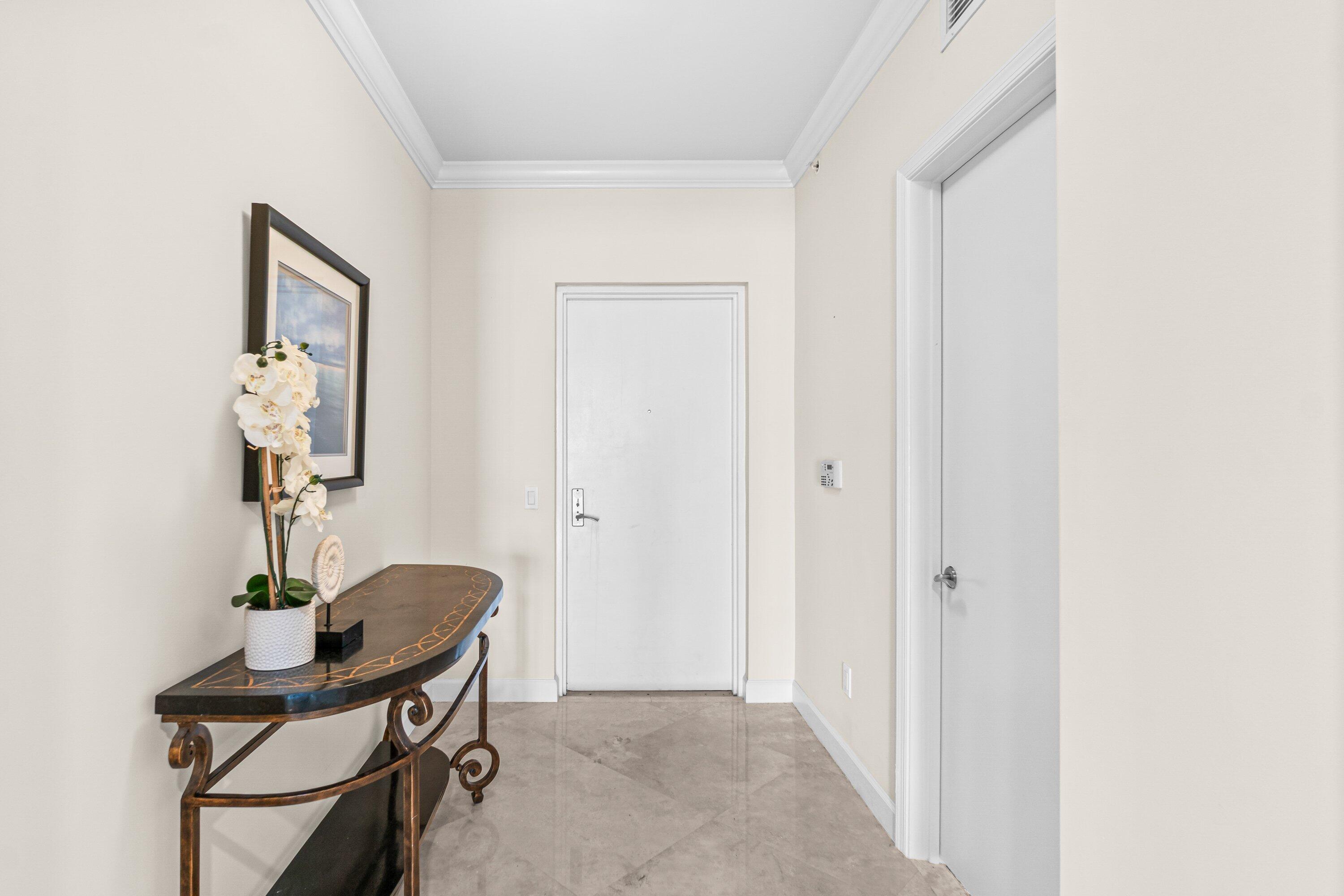 2650 Lake Shore Drive, Unit 703 Riviera Beach, FL 33404 - Photo 26 of 56 a view of a room that has a table and a chair in it